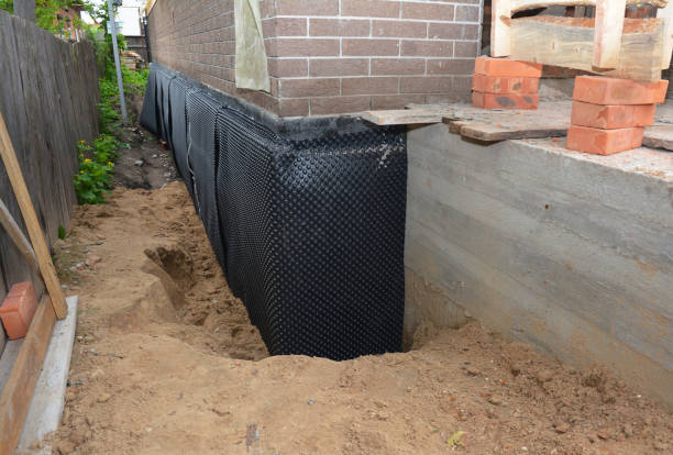 SJ Waterproofing Pros technician performing targeted Wet Basement Repair assessment in Brookpark, OH
